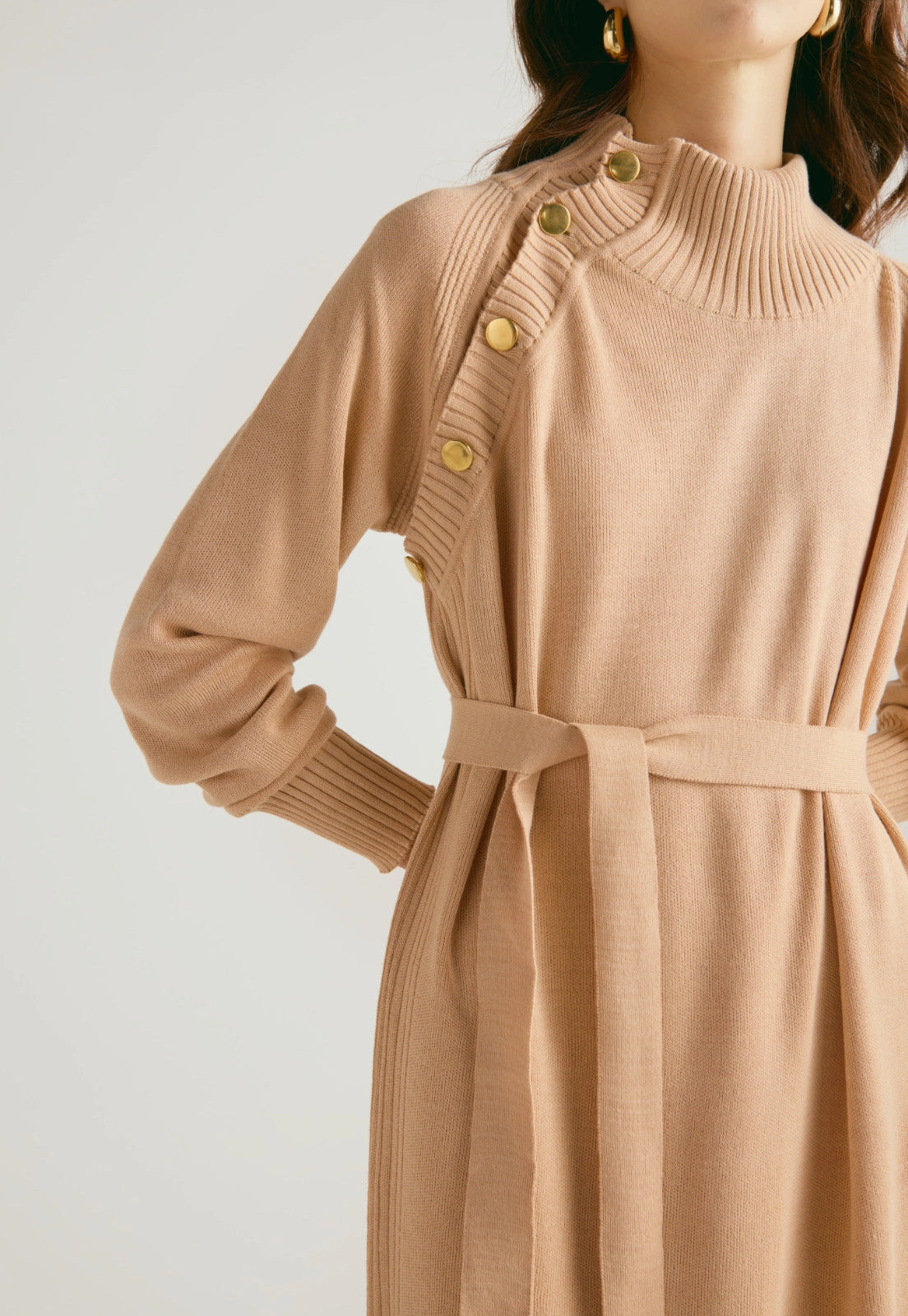 Vestido Danielle largo para mujer con cuello alto, botones dorados, cinturón ajustable y abertura en la falda, en tejido de punto cerrado.
